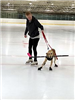 Benny and Trainer with a Hockey Stick