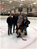 Benny with Their Trainer and Other Ice Rink Staff