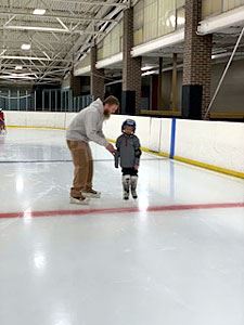 Father Assisting His Son in Skating