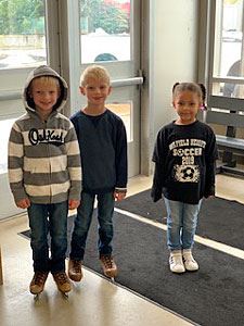 Three Kids at the Entrance of the Ice Rink