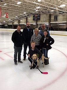 Benny with Their Trainer and Other Ice Rink Staff
