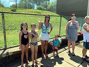 Woman and Young Girls Waving at the Camera
