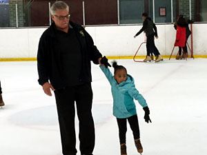 Dad and Daughter Skating on the Ice 2