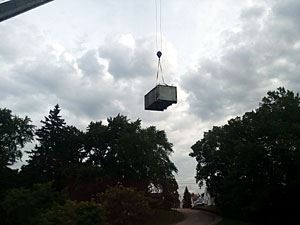 Condenser Being Held High in the Sky by a Crane