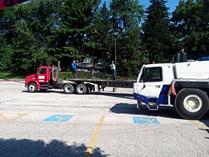 Crane and Flatbed Truck Parked Outside the Recreation Center