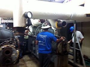 Workers Handling Overhead Pipes