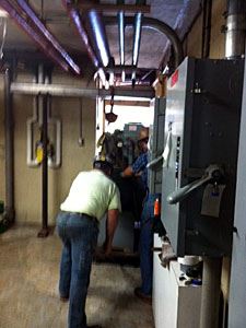 Workers Wheeling out Old Equipment