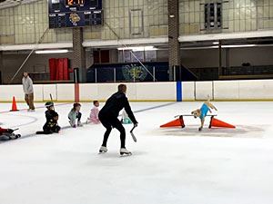 Benny Jumping over a Hurdle Towards His Trainer