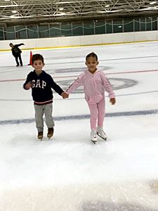 Siblings Skating While Holding Hands